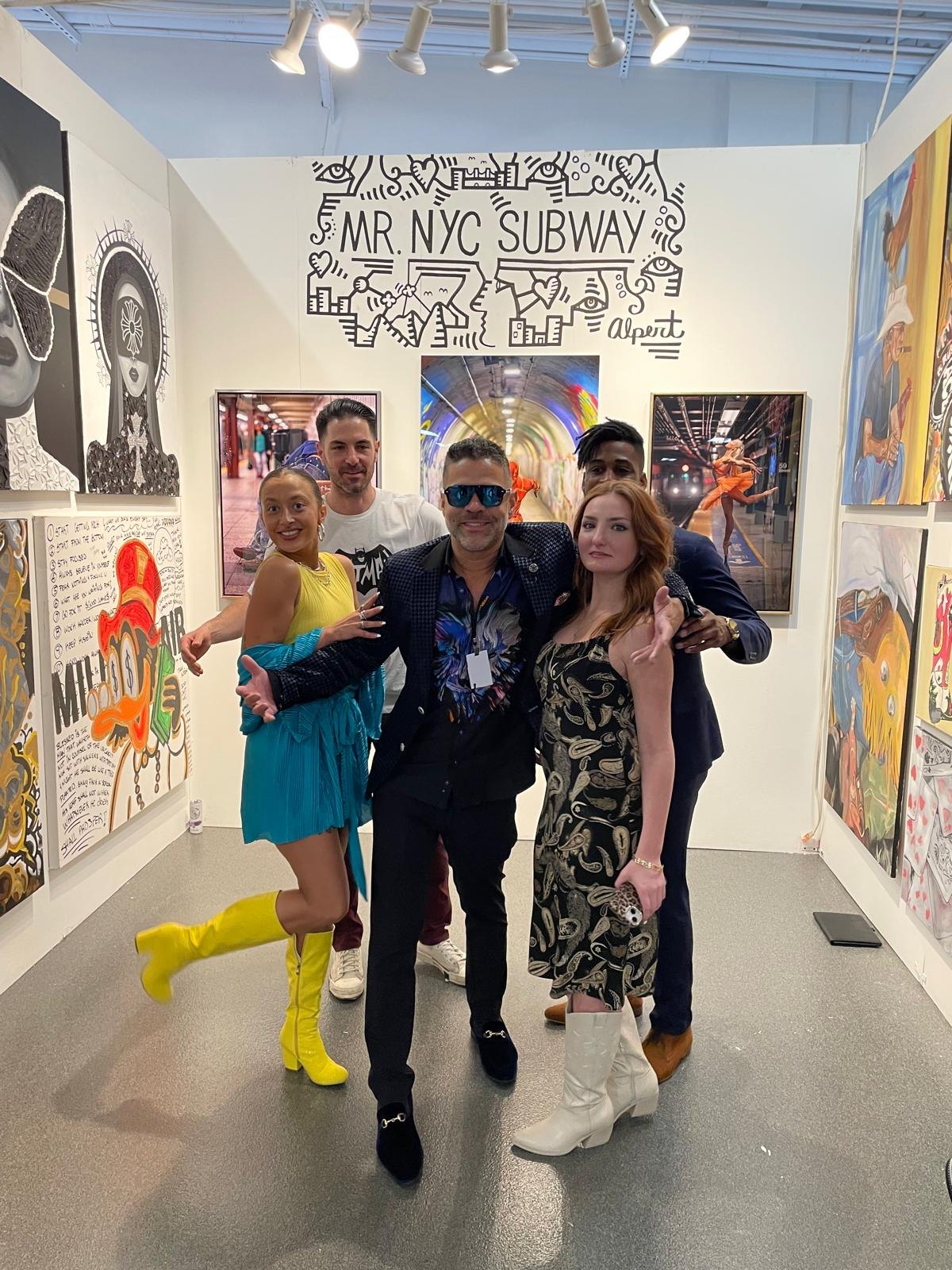 Jason Perez with guests at a colorful gallery event